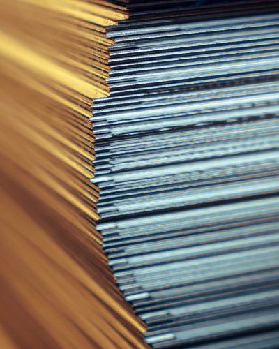Sheets of metal in a stack in a warehouse